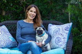 Patti Davis sits for a portrait with her pug, Lily, at her home on Thursday, Jan. 18, 2024 in Santa Monica