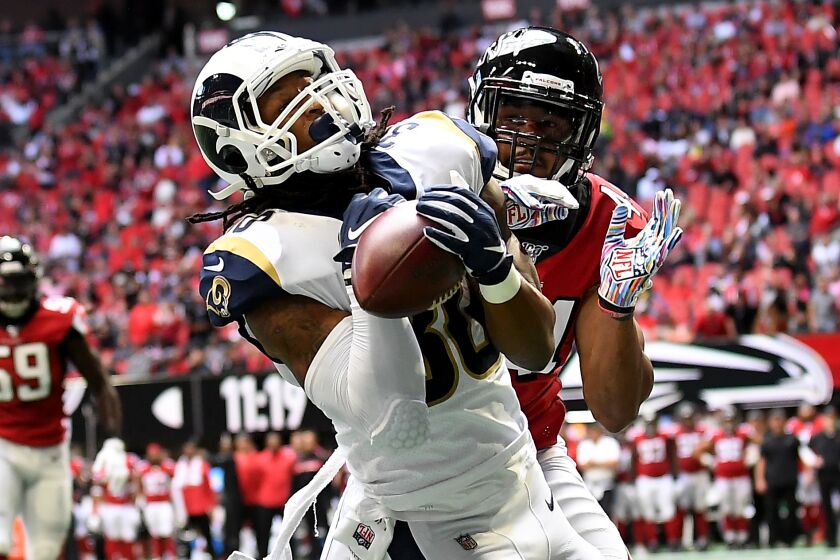 ATLANTA, GEORGIA OCTOBER 20, 2019-Rams running back Todd Gurley catches a touchdown pass in front of Falcons linebacker Vic Beasley Jr. in the 2nd quarter at Mercedez Benz Stadium in Atlanta Sunday. (Wally Skalij/Los Angeles Times)