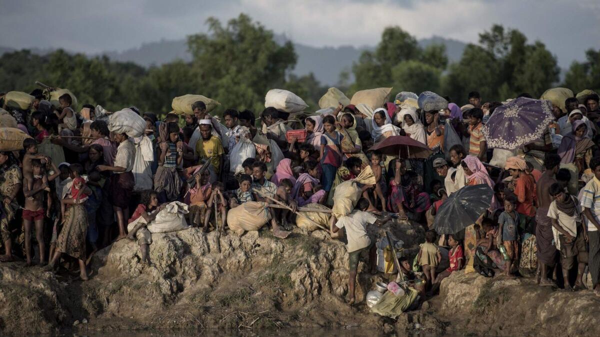 Rohingya refugees fleeing Myanmar in 20o17 arrive at the Naf river in Whaikyang at the Bangladesh border.