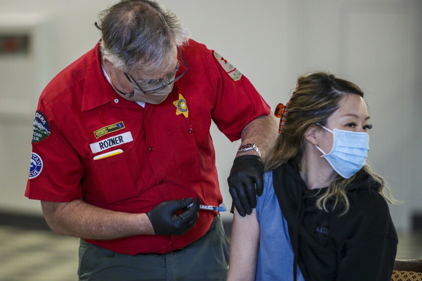 A COVID-19 vaccine is administered.