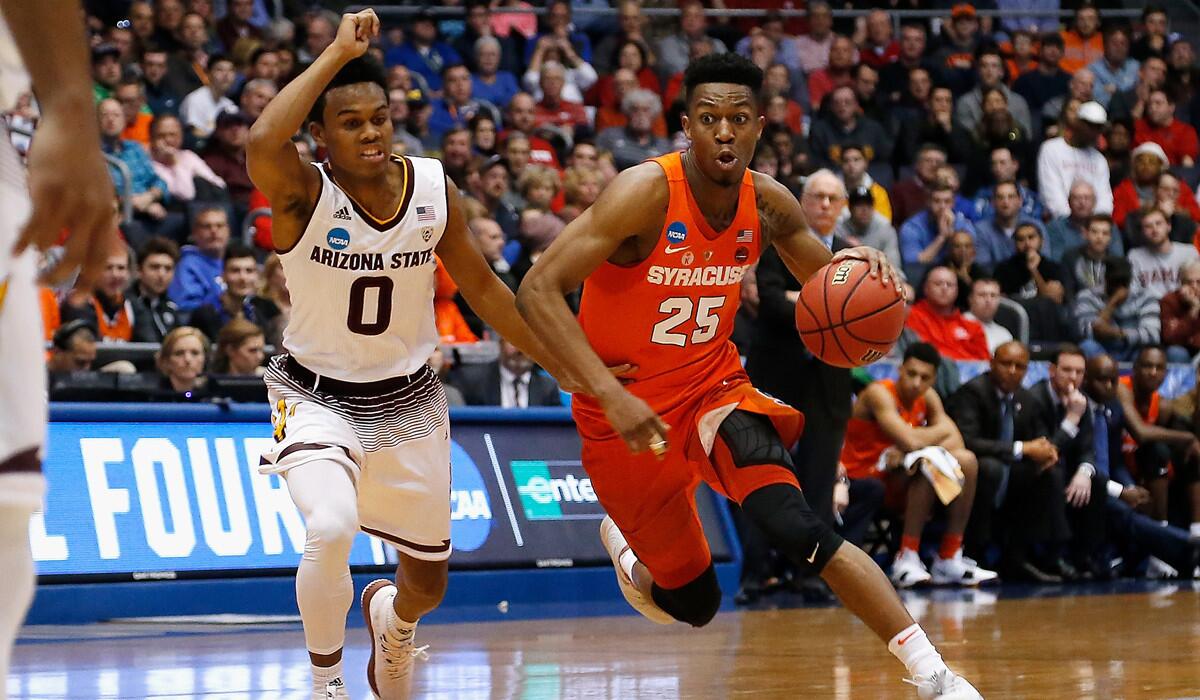 Syracuse's Tyus Battle dribbles the ball against Arizona State's Tra Holder during a First Four game of the NCAA tournament.