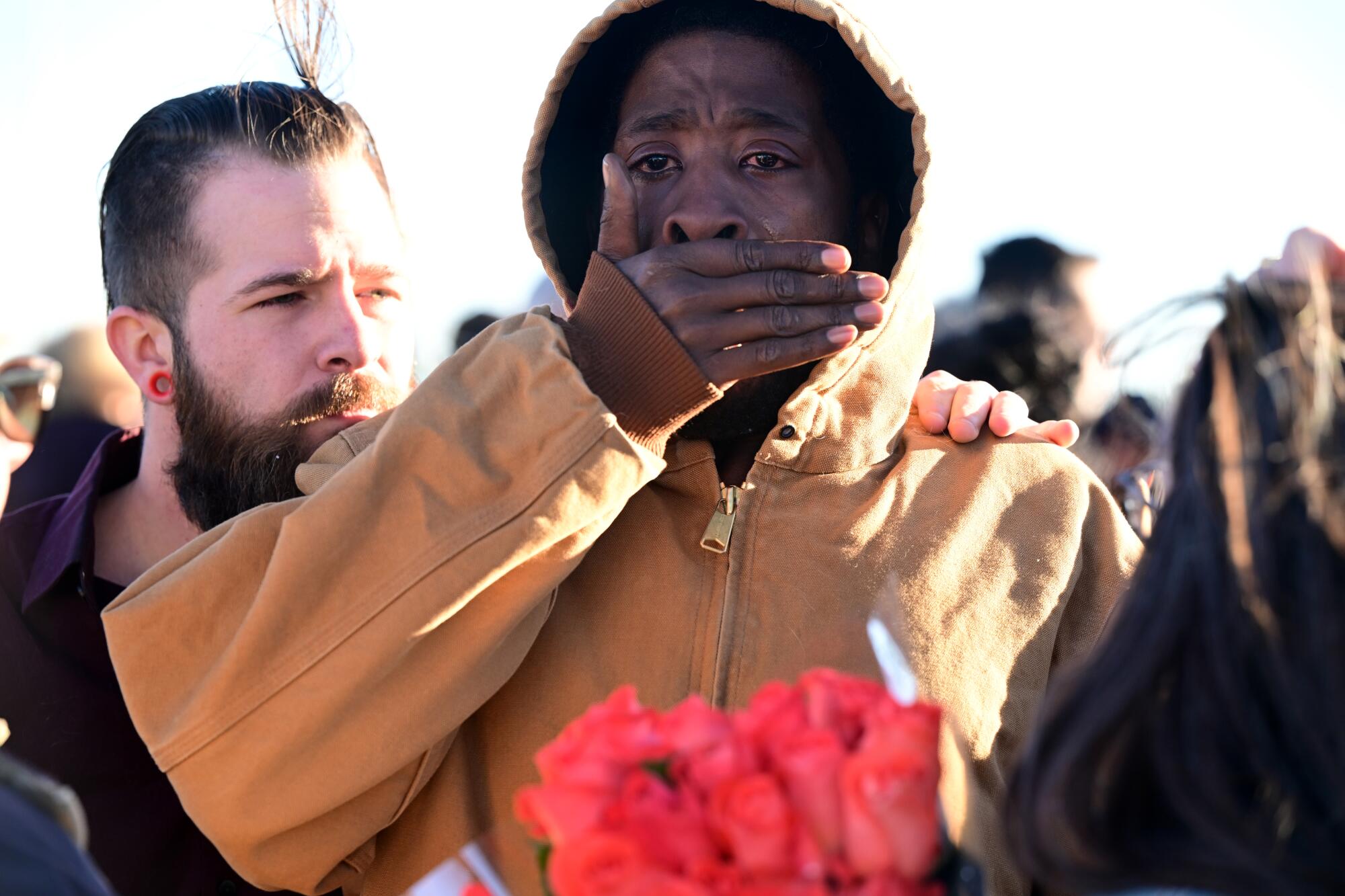 A man is comforted by his friend at a makeshift memorial near Club Q in Colorado Springs, Colo.