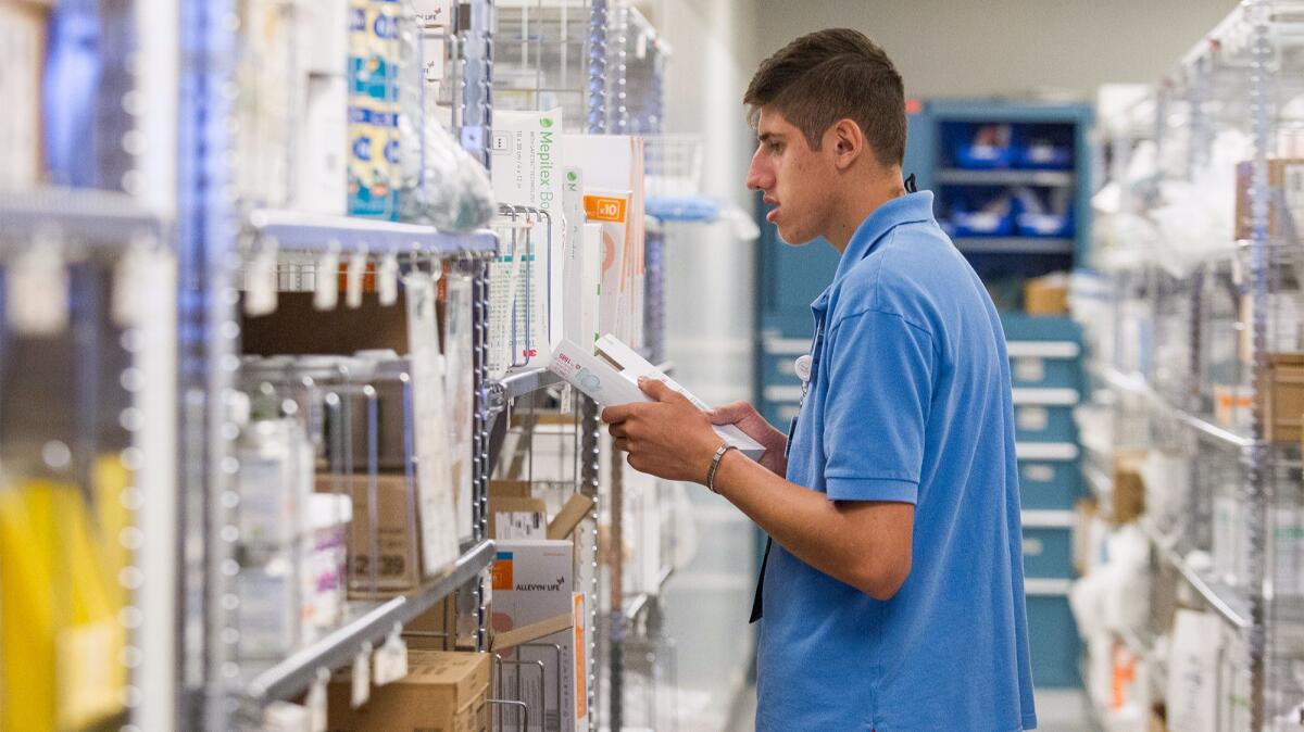STEP student Jaime Mendoza, 20, checks expiration dates on medicine at Hoag Hospital in Newport Beach, one of the program's more advanced work locations.