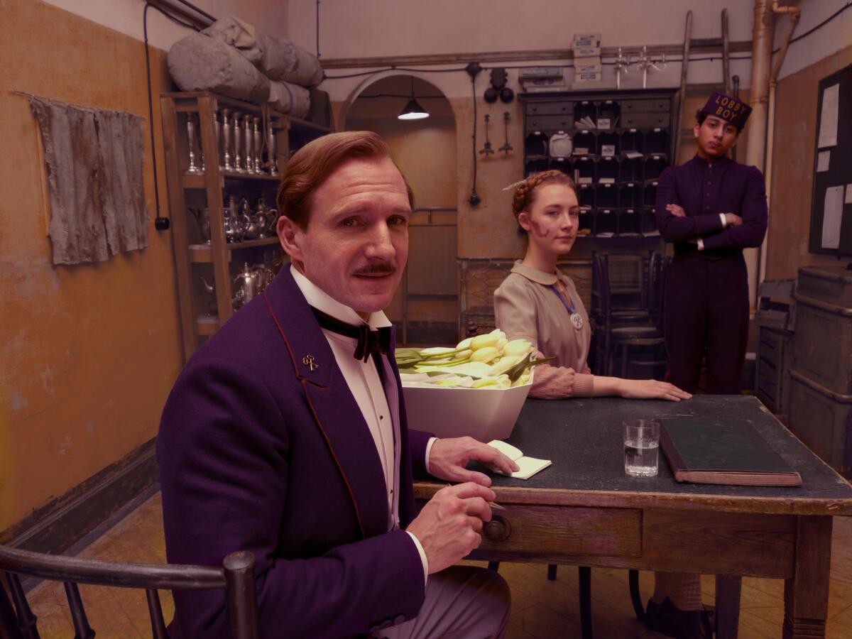 Ralph Fiennes as M. Gustave, Saoirse Ronan as Agatha and Tony Revolori as the lobby boy Zero in "The Grand Budapest Hotel."