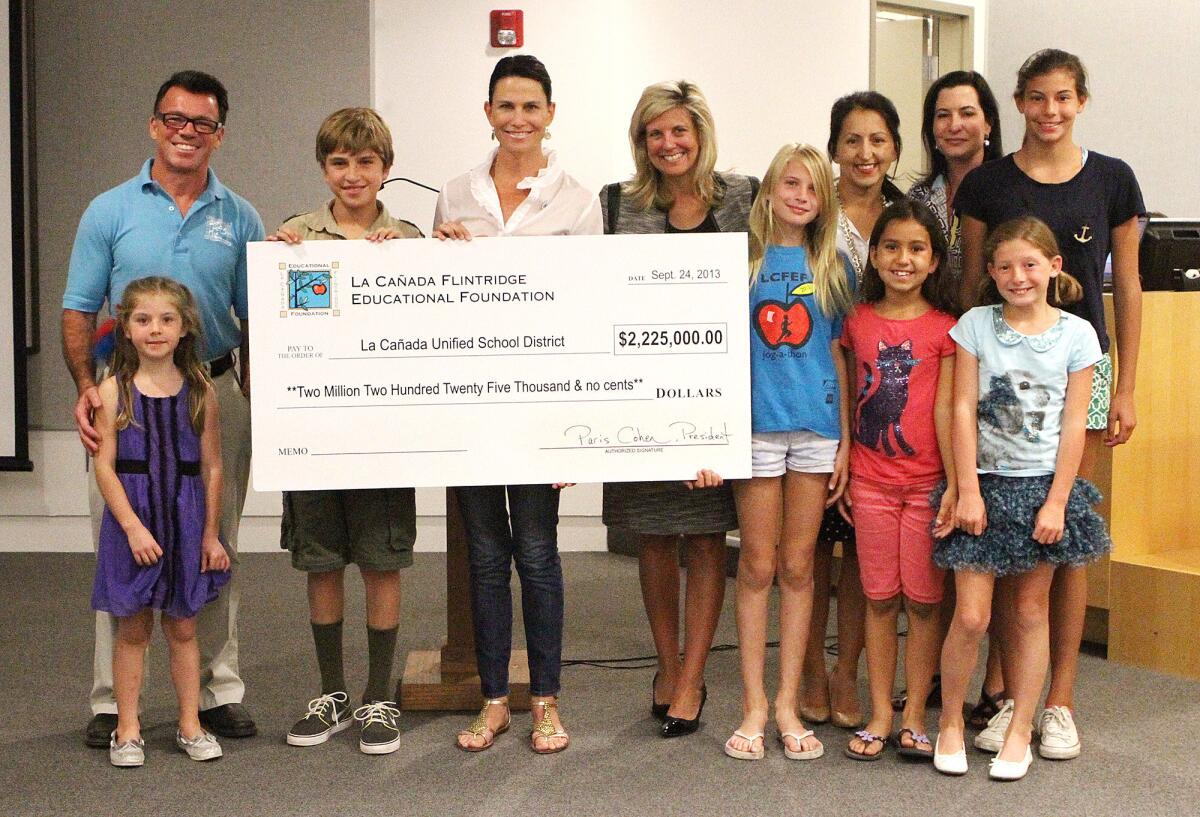 La Cañada Flintridge Educational Foundation administrators and their children present a big check to the La Canada Unified School District on Tuesday, September 24, 2013.