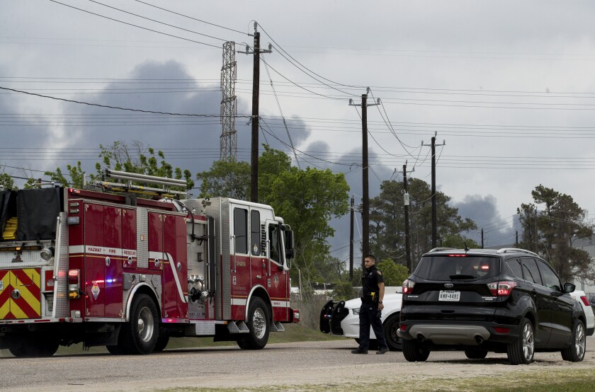 A Harris County Sheriff's Office deputy blocks Market Street, near Appelt Drive, as firefighters battle a fire at a chemical storage facility in the 1000 block of Lakeside Drive, on Wednesday, April 7, 2021, in Channelview, Texas. (Godofredo A. Vásquez/Houston Chronicle via AP)