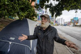 Los Angeles, CA - May 24: David Ruther, who says he's been homeless more than a decade, turned down Mayor Bass' Safe Inside program as he stands outside his tent, part of a homeless encampment on Broadway next to the public staircase in downtown Los Angeles Wednesday, May 24, 2023. Since taking office, Mayor Karen Bass has told audiences that she has found that L.A.'s unhoused will say yes when offered the chance to move inside. But in some locations, the mayor is hitting a wall - sending her Inside Safe team to encampments where not everyone has been willing to leave. On the sidewalks around the El Pueblo Historic Monument in downtown Los Angeles, some have decided to stay put. There and in other locations, new homeless people have quickly arrived, putting up new tents. (Allen J. Schaben / Los Angeles Times)