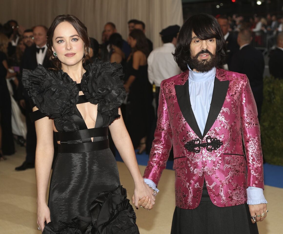 Dakota Johnson, left, and Gucci creative director Alessandro Michele hit the red carpet at the Met Gala.