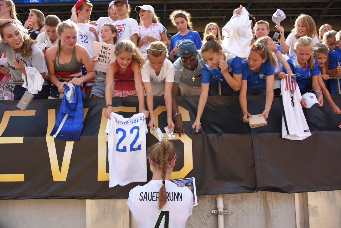 United States defender Becky Sauerbrunn (4) signs autographs following a women's friendly soccer match against Costa Rica, Sunday, Aug. 16, 2015, in Pittsburgh. (AP Photo/Don Wright)