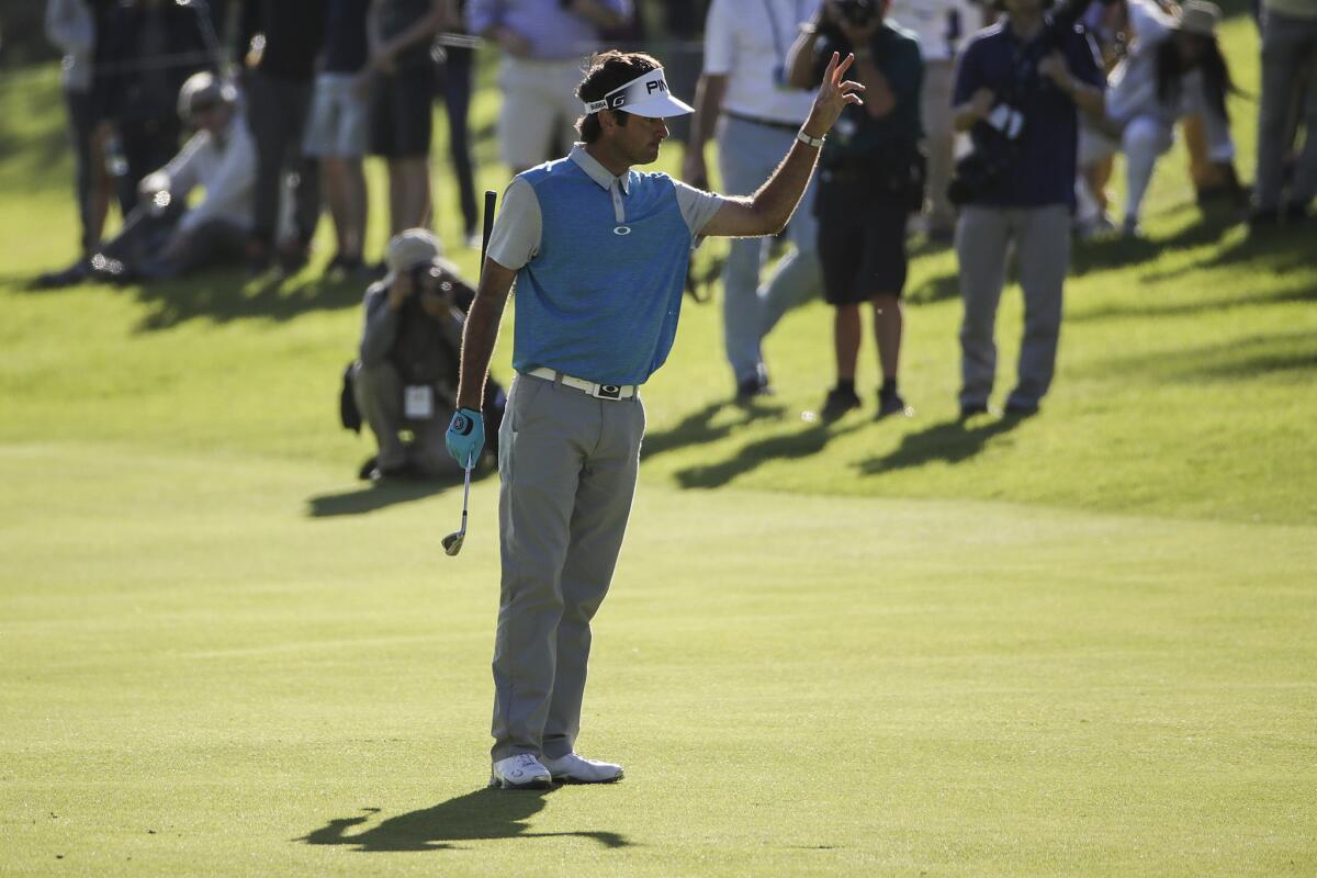 Bubba Watson waves to fans after hitting his approach at the 18th hole on Sunday during the final round of the Northern Trust Open.