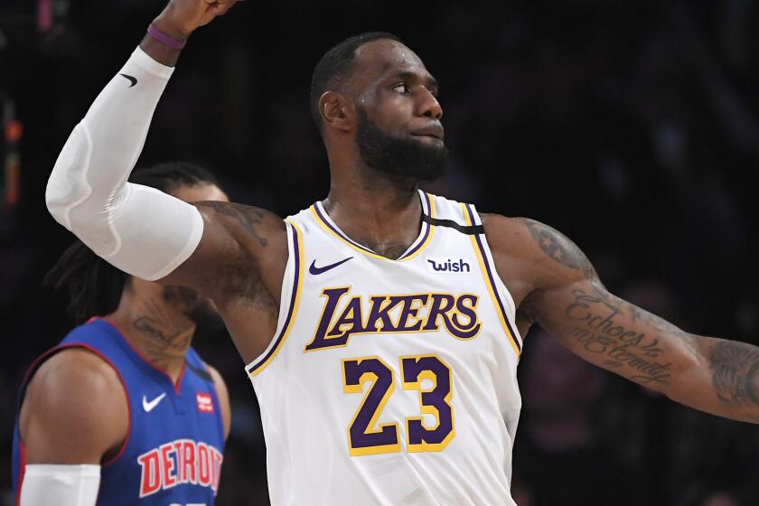 Los Angeles Lakers forward LeBron James, right, celebrates after the Lakers scored as Detroit Pistons guard Derrick Rose stands by during the second half of an NBA basketball game Sunday, Jan. 5, 2020, in Los Angeles. The Lakers won 106-99. (AP Photo/Mark J. Terrill)