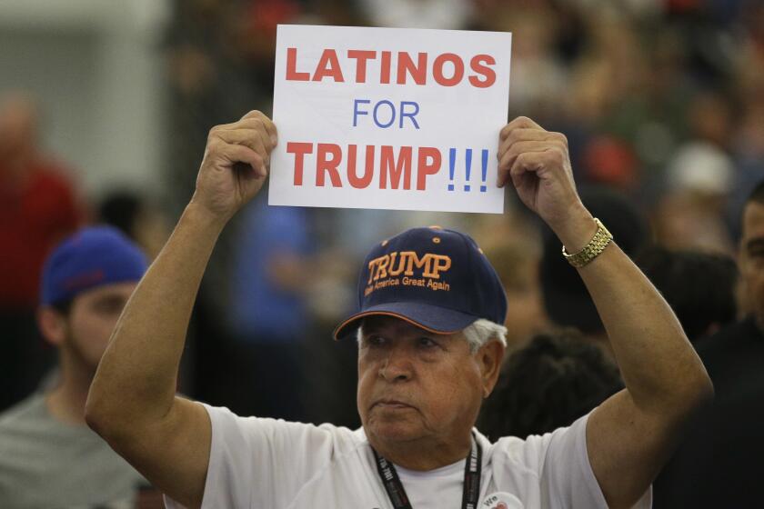 FILE - In this May 25, 2016, file photo, a man holds up a sign for then-Republican presidential candidate Donald Trump before the start of a rally at the Anaheim Convention Center, Wednesday, May 25, 2016, in Anaheim, Calif. Republicans are holding onto a steady share of the Latino vote in the Trump era. With a president who targets immigrants from Latin America, some analysts predicted a Latino backlash against the GOP. But it hasn’t happened. Data from AP’s VoteCast survey suggests Republicans are holding on to support from Latino evangelicals and veterans. (AP Photo/Jae C. Hong, File)
