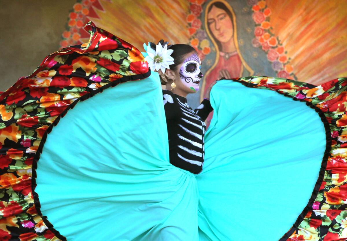 October 31, 2015_San Diego, California_USA_| At the Dia de los Muertos celebration in Old Town Yesenia Garcia with Real de San Diego dance academy, of Chula Vista, performs with others on the stage at Fiesta de Reyes plaza. |_Mandatory Photo Credit: Photo by Charlie Neuman/San Diego Union-Tribune/©2015 San Diego Union-Tribune, LLC