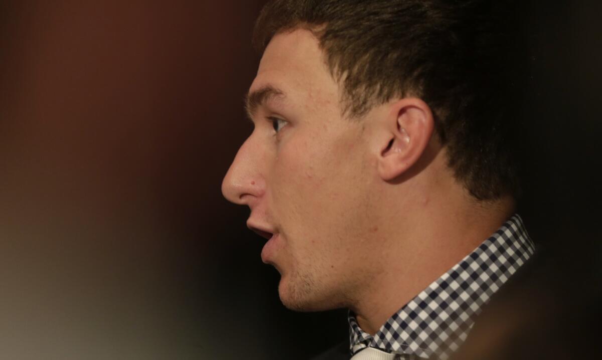 Texas A&M; quarterback Johnny Manziel talks to reporters Wednesday during SEC Media Days in Hoover, Ala.
