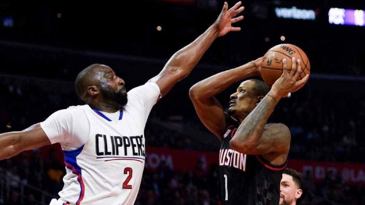 Clippers guard Raymond Felton contests a shot by Rockets forward Trevor Ariza during a March 1 game at Staples Center.