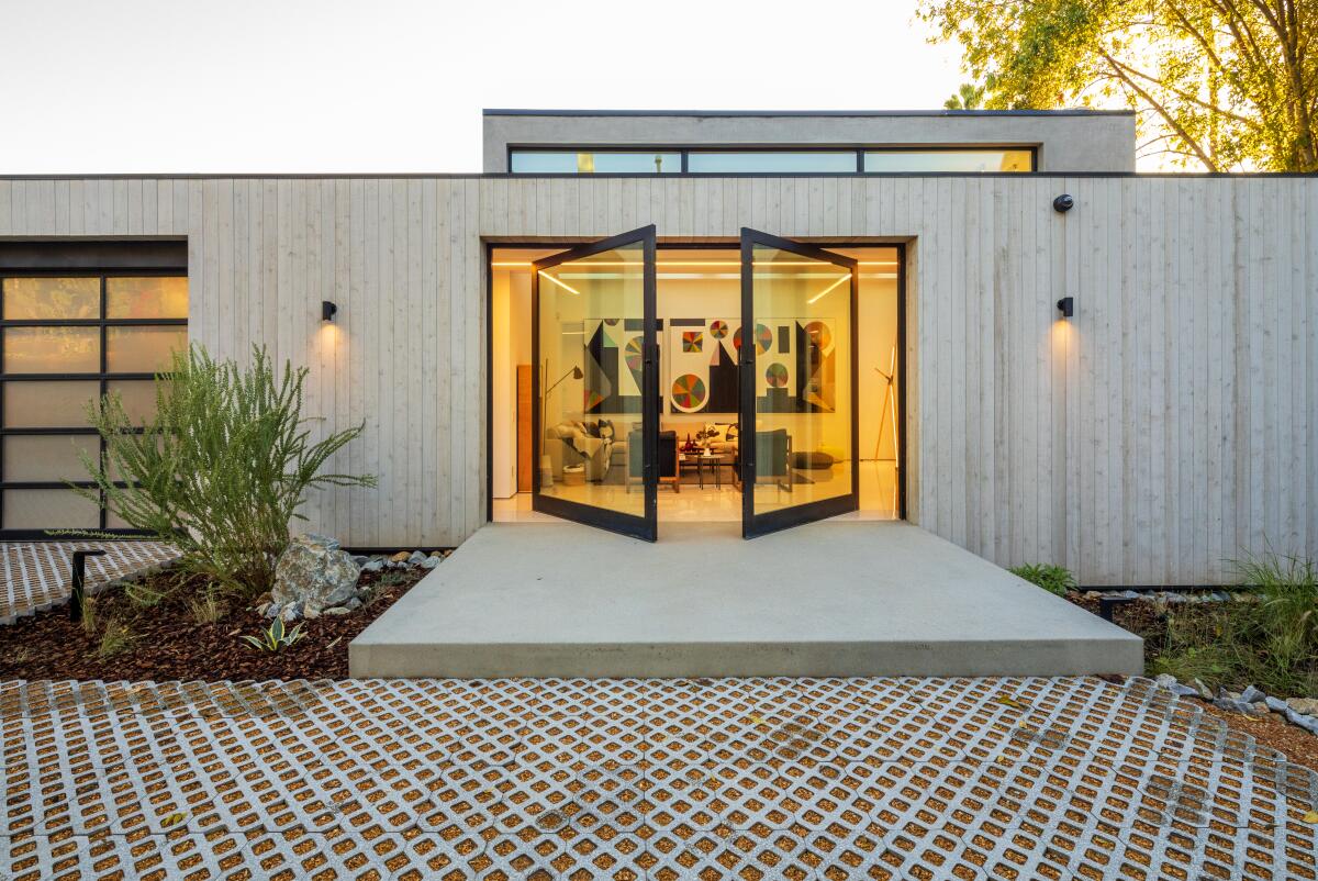 The entrance to Dan Brunn's home, with side-by-side glass doors opening outward.