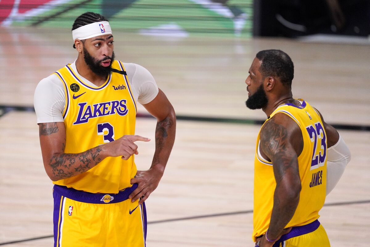 Anthony Davis talks with LeBron James during the second half.