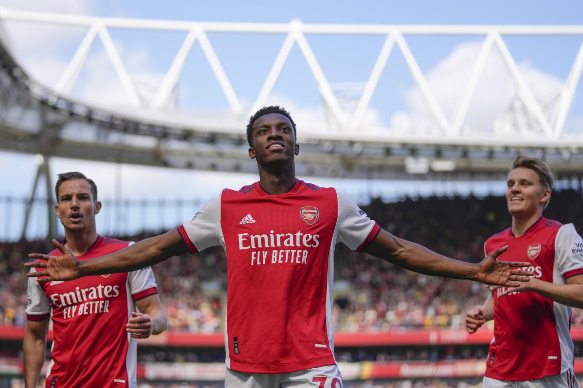 Arsenal's Eddie Nketiah, center, celebrates with teammates after scoring during the English Premier League soccer match between Arsenal and Leeds United at the Emirates Stadium, in London Sunday, May 8, 2022. (AP Photo/Frank Augstein)