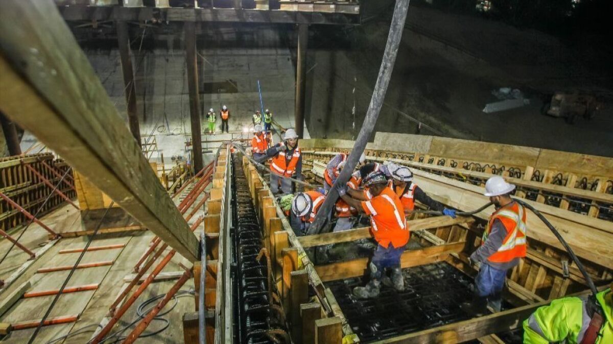 Construction crews pour cement during a nighttime operation at the Gilman Bridge over Interstate 5 in La Jolla, as part of the construction on the Mid-Coast Trolley extension. The roughly $2 billion project is expected to be completed by 2020.