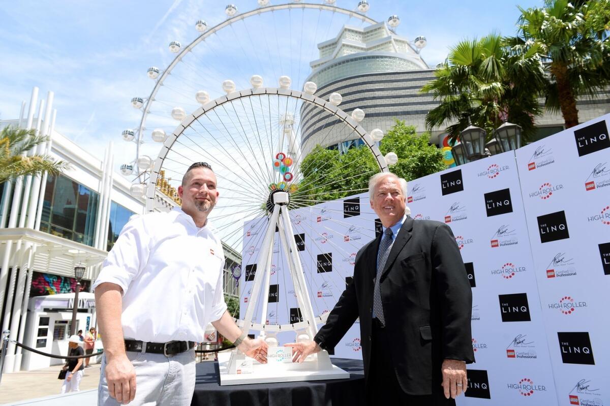 Adam Reed Tucker from Lego and High Roller general manager Eric Eberhart show off the replica of the High Roller.