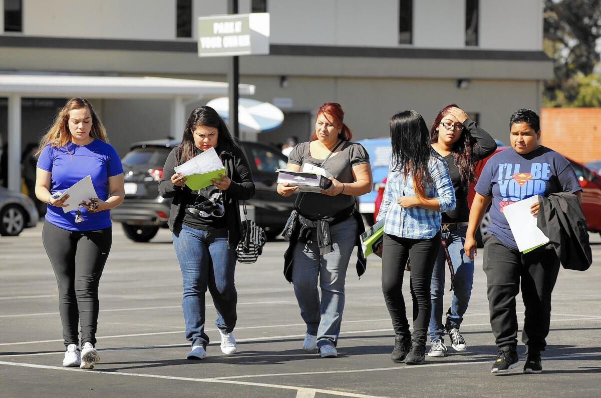 At Everest College-Alhambra, which had been abruptly shut down, students leave the campus with paperwork given to them by the State Department of Consumer Affairs.