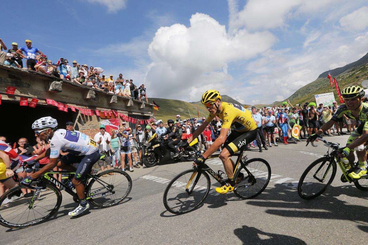 Colombia's Nairo Quintana, wearing the best young rider's white jersey, and Britain's Chris Froome, wearing the overall leader's yellow jersey, climb Glandon pass during the Stage 18 of Tour de France on Thursday.