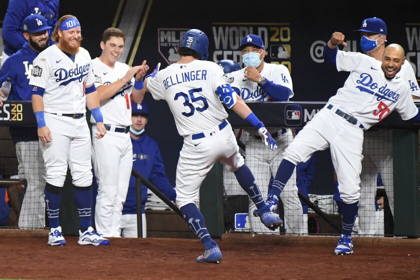 ARLINGTON, TEXAS OCTOBER 20, 2020-The Dodgers dugout celebrates Cody Bellinger's two-run home run against the Rays in the 4th inning in Game 1 of the World Series at Globe Life Field in Arlington, Texas Tuesday. (Wally Skalij/Los Angeles Times)