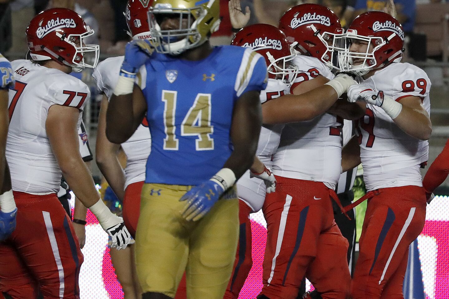 Fresno State tight end Kyle Riddering, right, is congratulated by teammates after making a touchdown catch against UCLA in the first quarter on Saturday.
