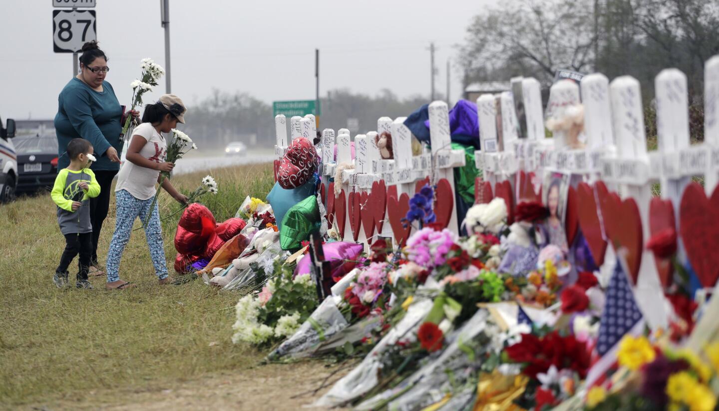 Christina Osborn and her children Alexander Osborn and Bella Araiza visit a makeshift memorial for the victims of the shooting at Sutherland Springs Baptist Church on Nov. 12, 2017, in Sutherland Springs, Texas.