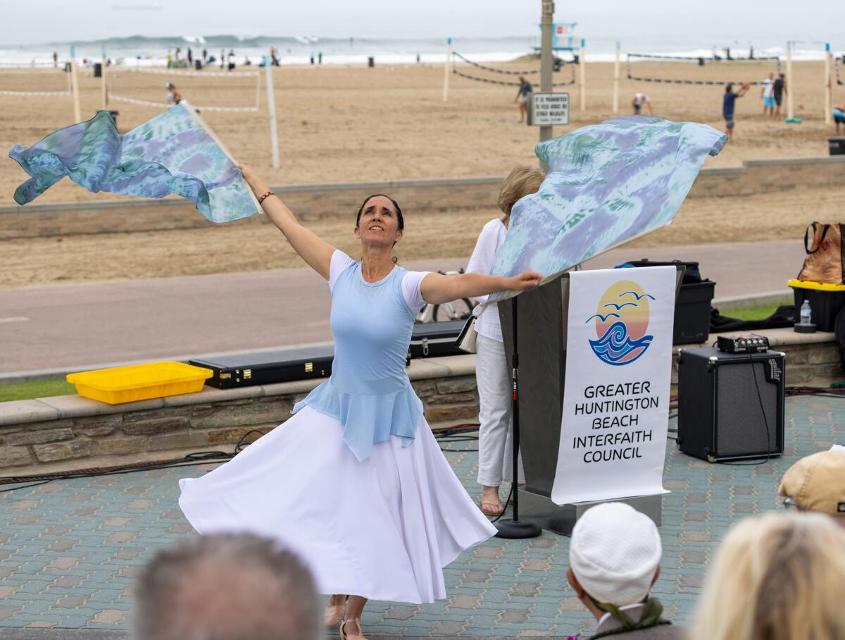 Christy Hernandez of Saints Simon & Jude Catholic Church performs during the Blessing of the Waves on Sunday morning.