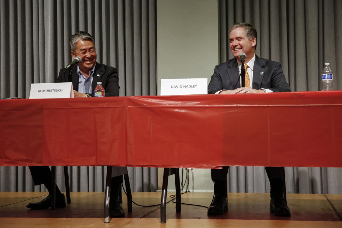 Al Muratsuchi, left, and David Hadley speak at a candidates forum in Torrance.