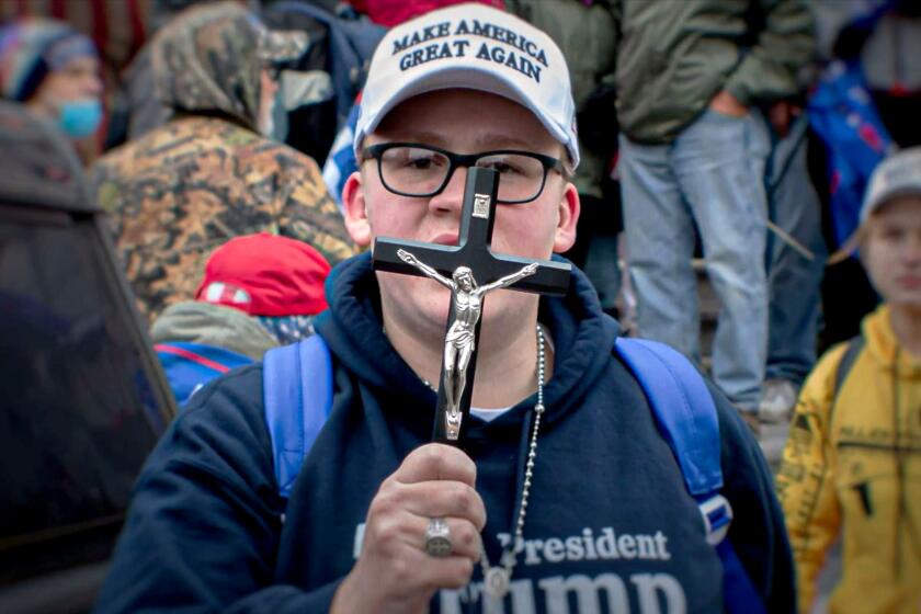 Still shot from (and courtesy of) the 2024 documentary "Bad Faith: Christian Nationalism's Unholy War on Democracy." The photo is of an unidentified protester on Jan. 6, 2021, outside the Capitol, where Trump supporters tried to derail Congress as it counted and certified the 2020 electoral college results.