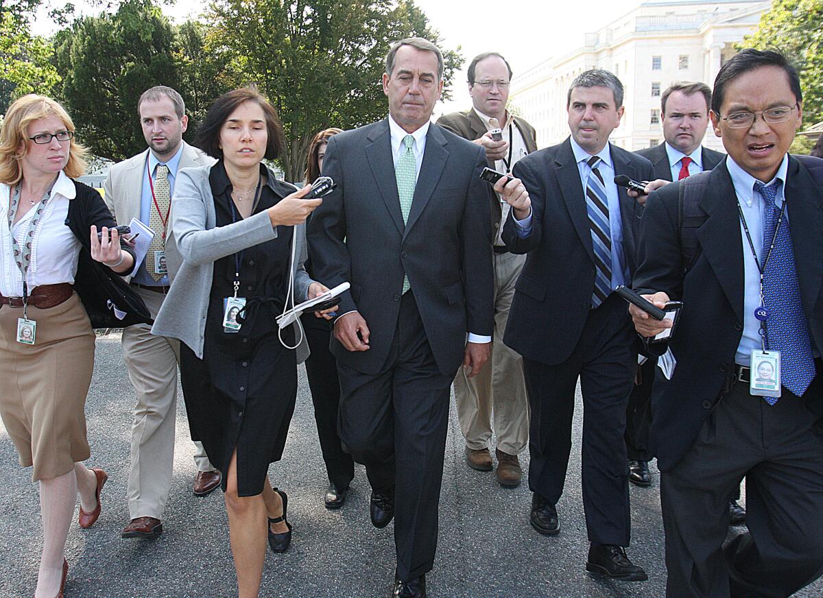 John Boehner, then the House minority leader, is trailed by reporters on Capitol Hill in 2008.