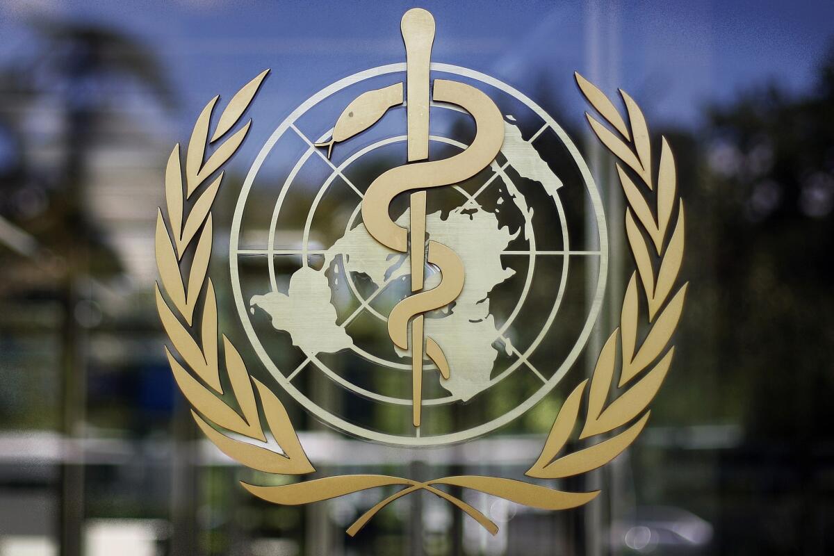 The logo of the World Health Organization on a glass window