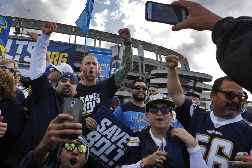 Former Charger player Nick Hardwick (wearing Save Our Bolts T-shirt) whips up the crowd at a rally outside Qualcomm Stadium before a meeting of a committee exploring a new stadium for the Chargers.