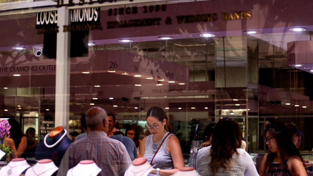 Shoppers look over jewelry inside the Western Jewelry Mart on 6th Street in downtown Los Angeles.