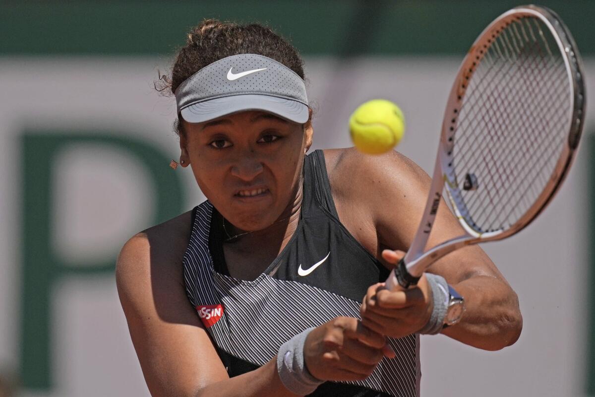 Naomi Osaka hits a return during her first-round victory over Patricia Maria Tig at the French Open on Sunday.