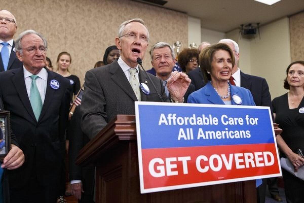 Senate Majority Leader Harry Reid (D-Nev.) and House Minority Leader Nancy Pelosi (D-Calif.) celebrate the start of the Affordable Care Act on Tuesday.