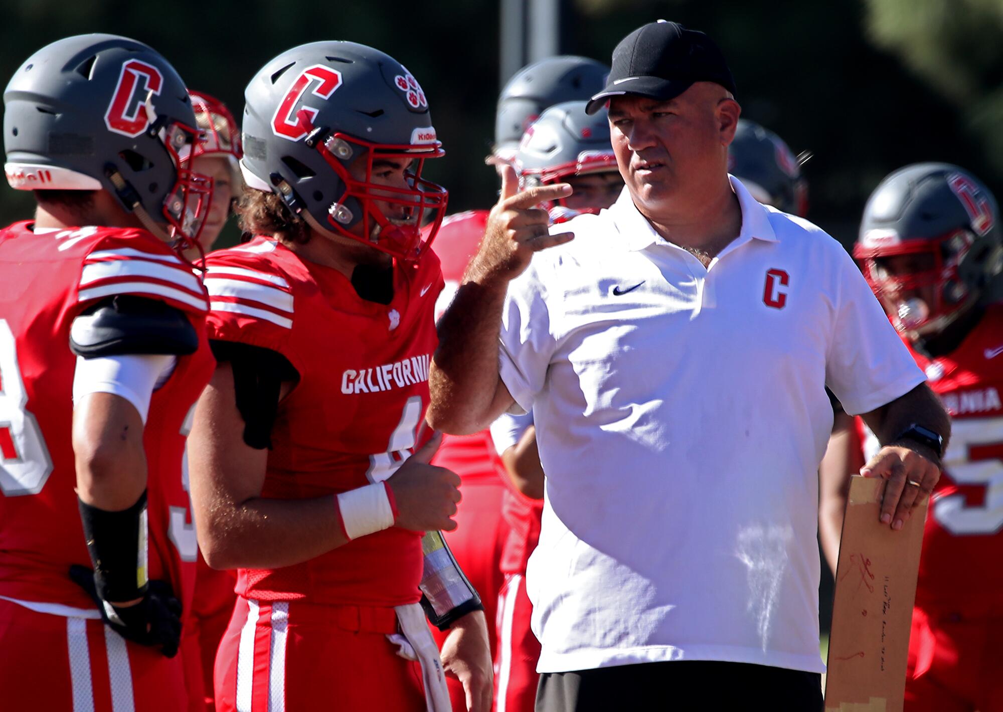 CSDR football coach Keith Adams communicates with his players in sign language during a game.