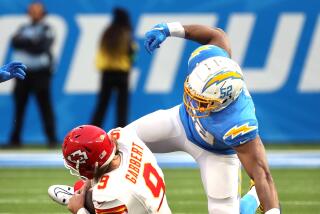 Chargers linebacker Khalil Mack tries to strip the ball away from Chiefs quarterback Blaine Gabbert.