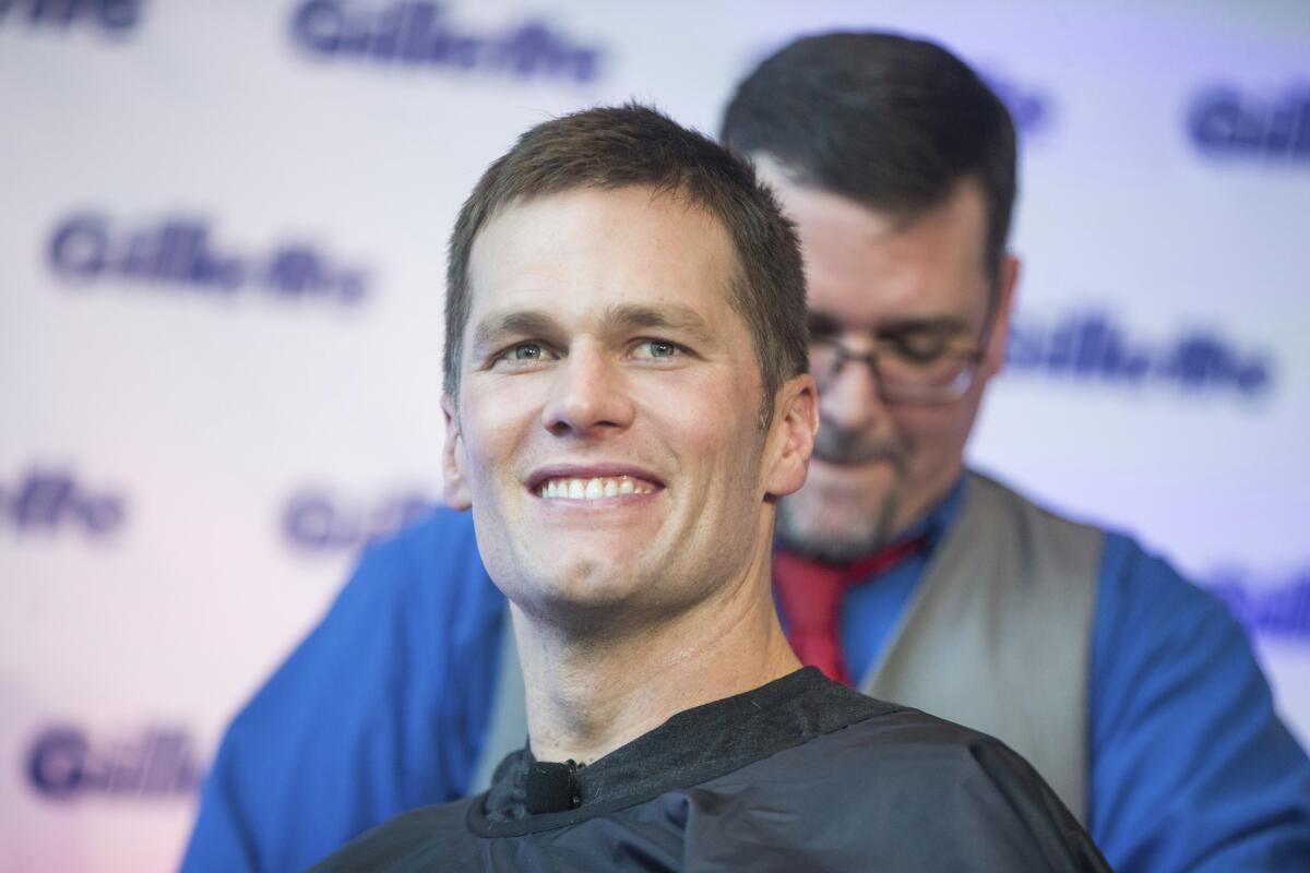 Well-groomed Super Bowl champion Tom Brady celebrates with a victory shave at Gillette World Shave headquarters on Thursday, Feb. 07, 2019 in Boston. Three New England Patriots-branded Gillette razor handles and boxes signed by Brady will be auctioned off for charity in the coming days.