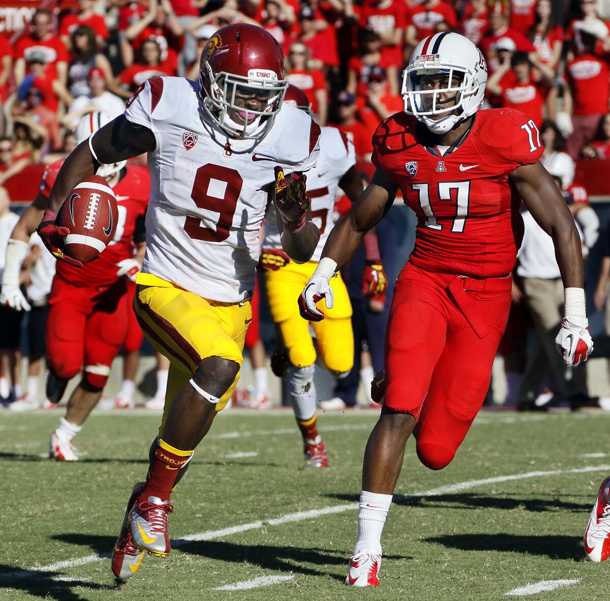 USC's Marqise Lee runs for a touchdown as Arizona's Derrick Rainey purses during a 2012 game. 