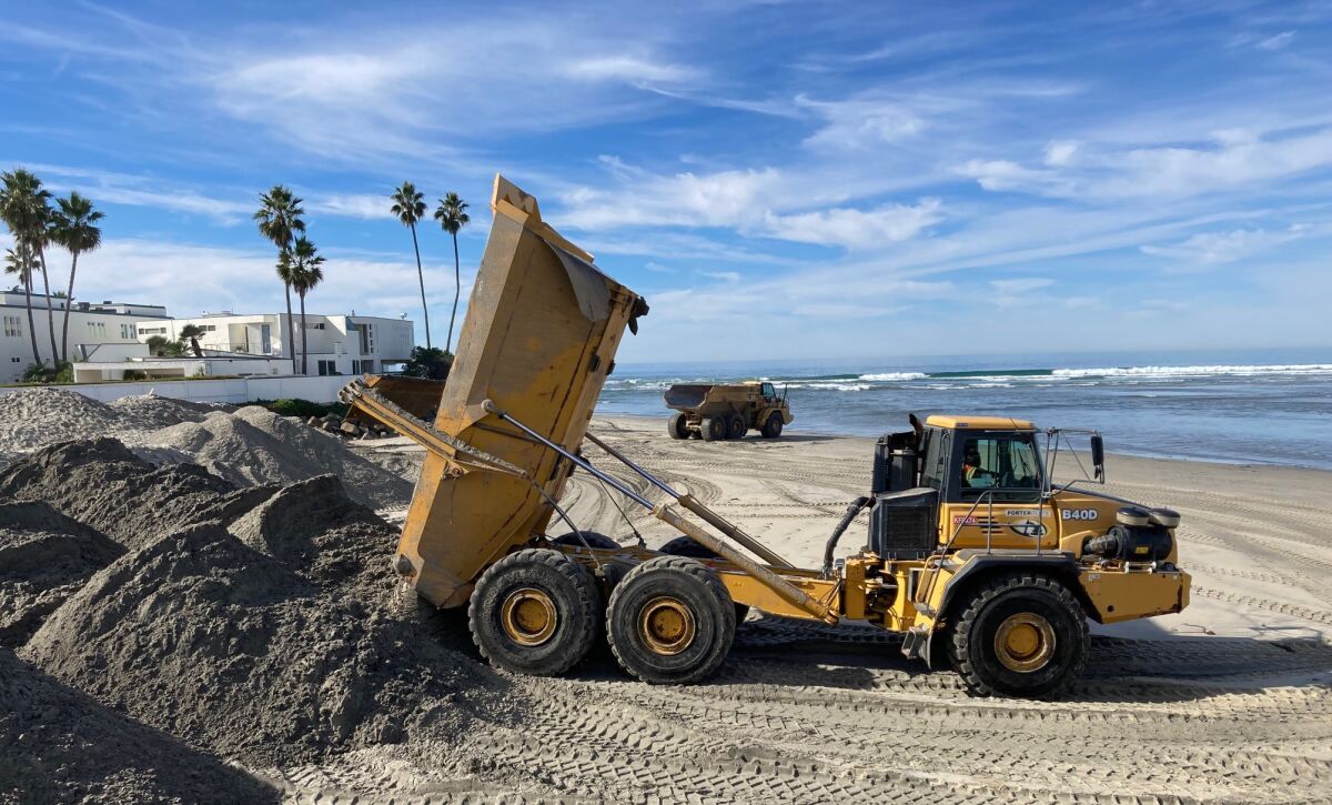 Sand from the San Dieguito Lagoon is dumped near the San Dieguito River mouth Monday during maintenance of nearby wetlands.