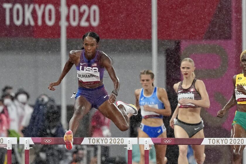 Dalilah Muhammad, of United States races to win a heat.