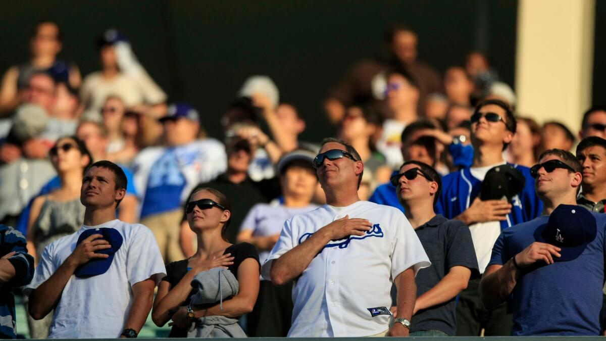 Fans during the national anthem at Dodger Stadium.