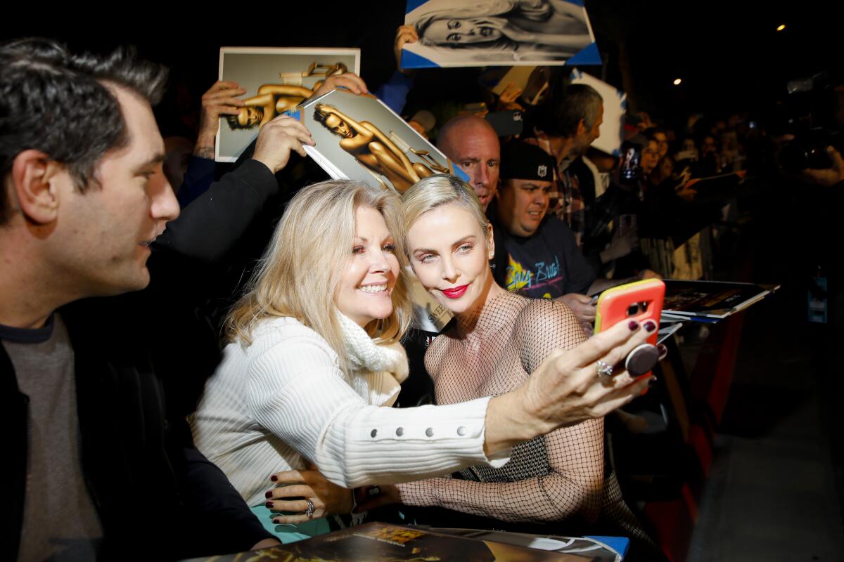 Charlize Theron poses for photos with movie fans at the Palm Springs International Film Festival Awards Gala