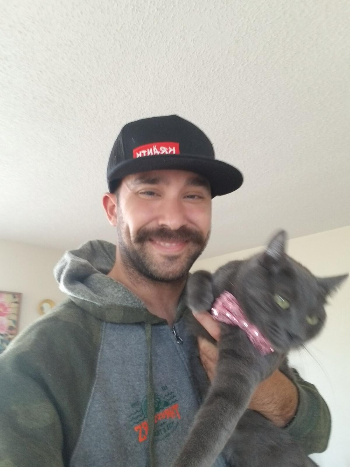 Nicolas Perez with Kittanha, his new cat recently adopted from Cat Palace by Champagne Queen