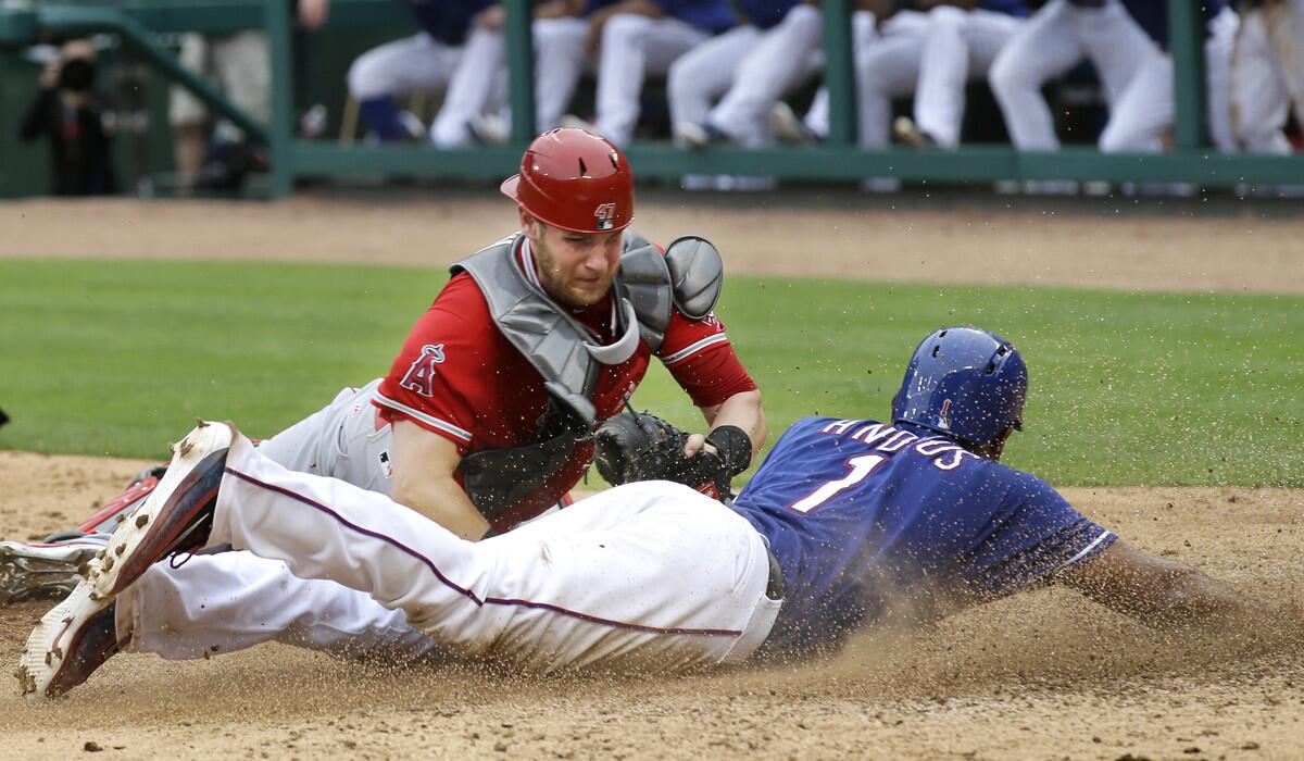 Texas Rangers Elvis Andrus, right, slides into home plate scoring against Angels catcher Jett Bandy during the sixth inning Wednesday.