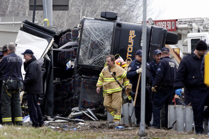 Emergency personnel investigate the scene of a bus crash in the Bronx borough of New York in March 2011.