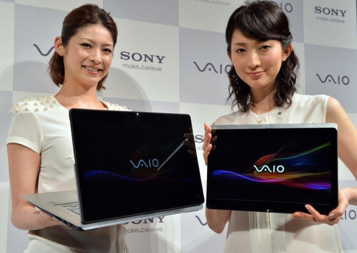 Sony is warning users of its Vaio Fit 11A that the laptop could contain a fire risk. Above, Sony reps with Vaio devices.